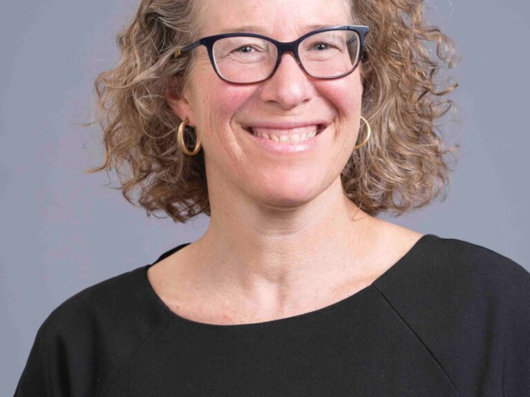 Head shot, White woman with shoulder length blonde hair and glasses